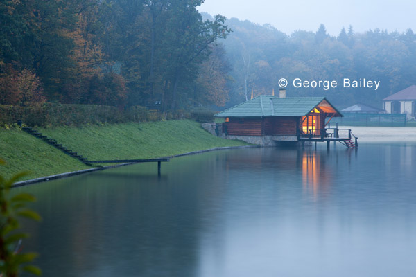 Cabin at the river bank in the mountains